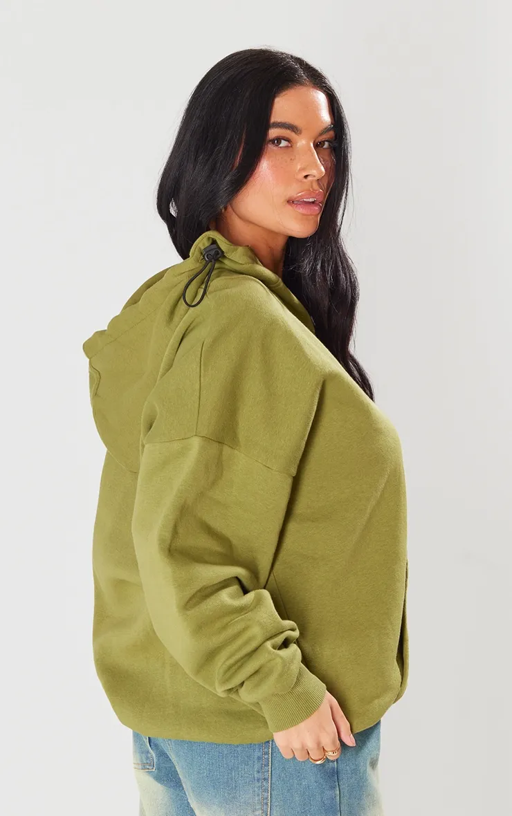 Hoodie vert olive à demi-zip et coutures apparentes