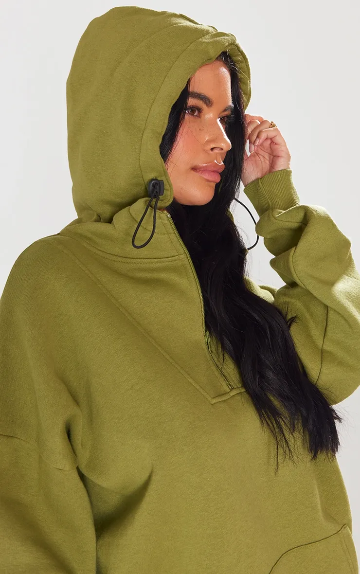 Hoodie vert olive à demi-zip et coutures apparentes